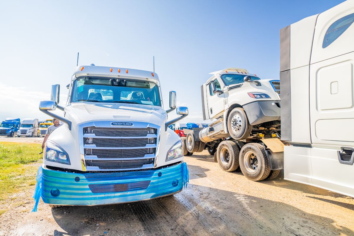 deck driving driveaway — Freightliners connected for transport